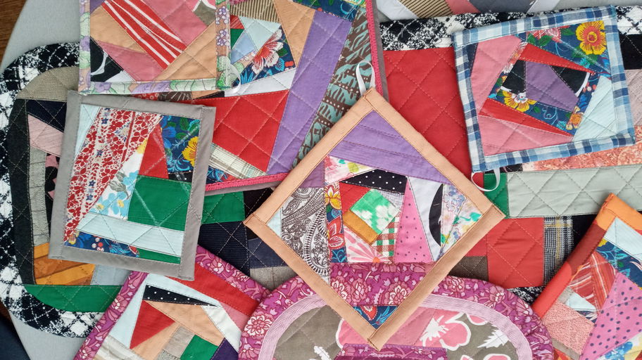 Handmade patchwork potholders and coasters made from leftover quilting fabric scraps